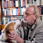 Senior man and his dog at home; canine communication and dog behavior
